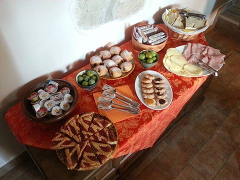 An assortment of foods on a set table, perfect for a hearty and pleasant breakfast.
