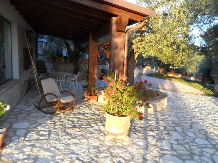 A simple terrace surrounded by plants and flowers, perfect for spending time outdoors.