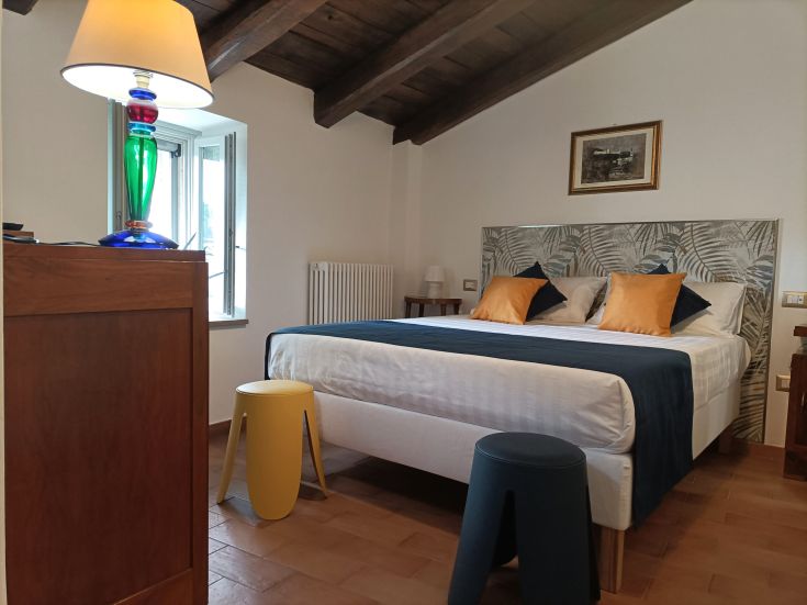 Simple yet comfortable room with practical furniture and modern elements, ideal for a serene stay.