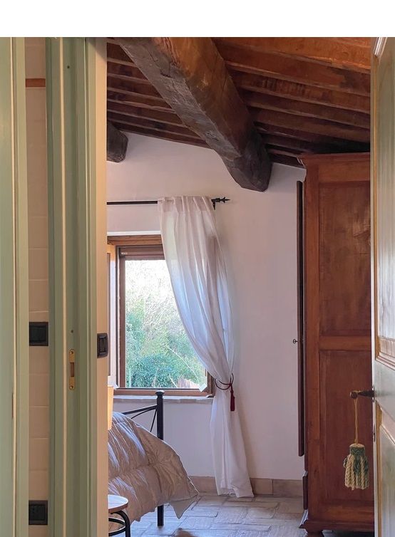 Bright and welcoming room with windows offering views of lush greenery, perfect for a serene stay.