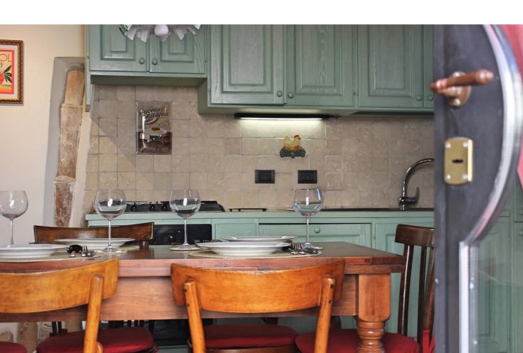 Rustic kitchen design with wooden furniture and ready meals on the table. Cozy and warm atmosphere.