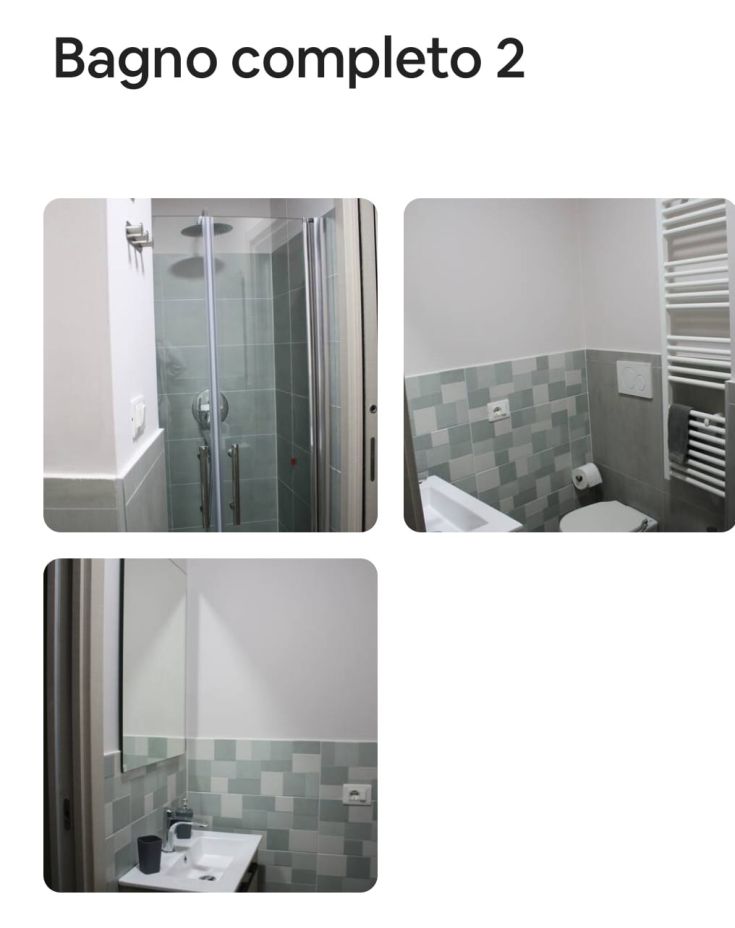 Bagno moderno con doccia e lavabo, ben illuminato e arredato in modo semplice.