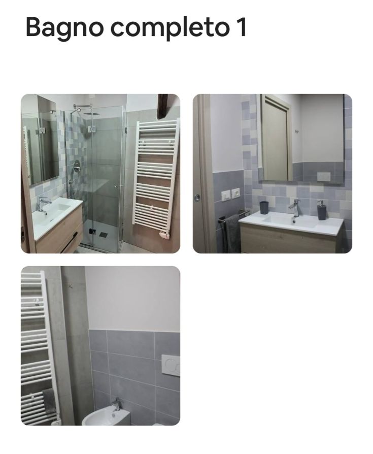 Bagno arredato con doccia, lavabo e sanitari. Stile semplice e luminoso, con tonalità chiare.