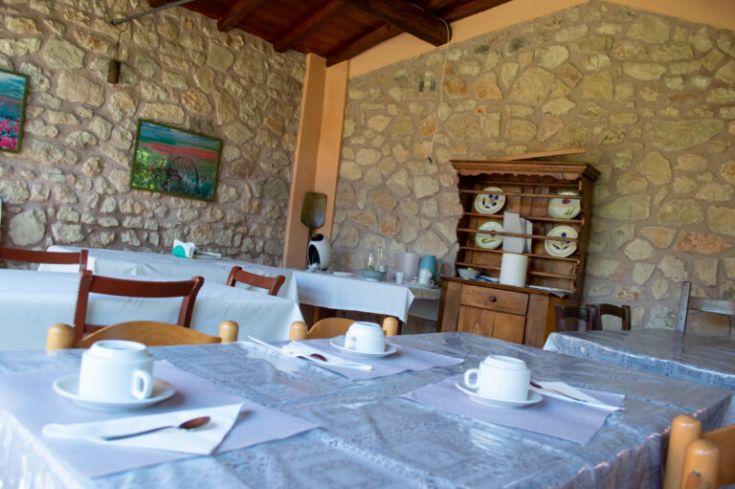 Ambiente rustico con tavoli semplici, perfetto per una colazione serena in campagna.