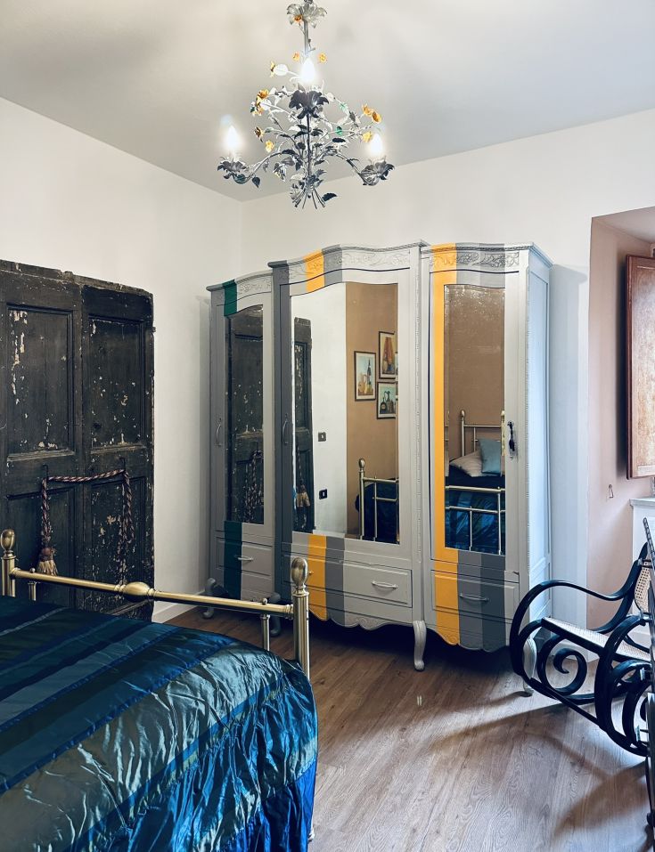 Einfaches und gemütliches Zimmer in einem historischen Gebäude mit Vintage-Möbeln und einer ruhigen Atmosphäre.