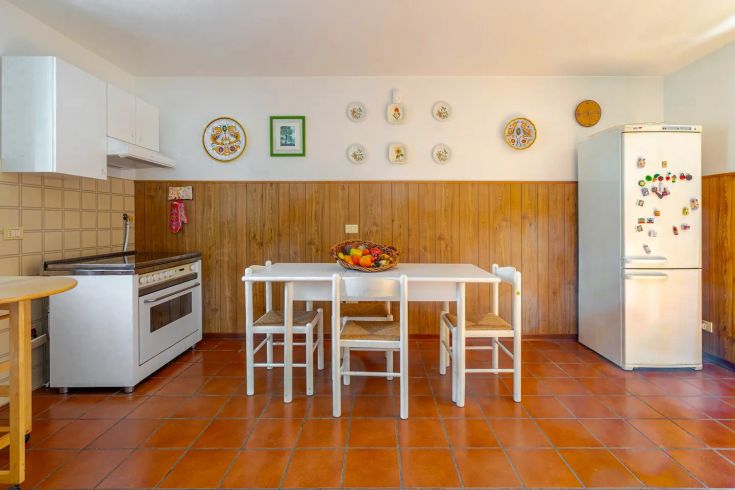 Bright and cozy kitchen featuring a table, chairs, and simple decorative elements.