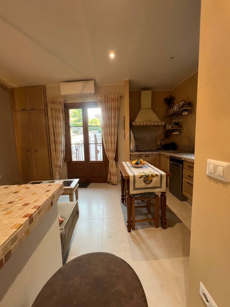 Modern renovated kitchen with updated appliances and functional furnishings. Bright and airy environment.