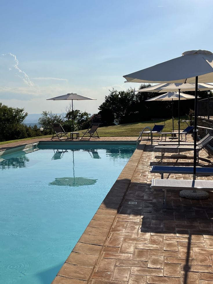 The pool at Villa Gosparini is nestled in greenery, providing a serene atmosphere for relaxation.