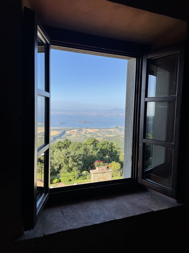 A view of the Umbrian countryside and Lake Trasimeno from an open window.