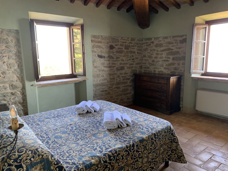 Cozy room overlooking the surrounding greenery, perfect for a peaceful stay in Umbria.