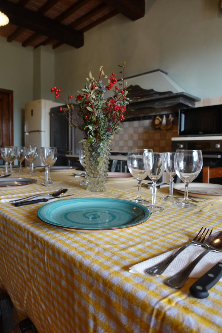 A beautifully set table with floral decorations and dishes ready for an intimate dinner.