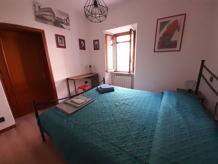 Chambre simple avec un lit double, des éléments décoratifs modernes et quelques touches vintage. Convient pour un séjour paisible.