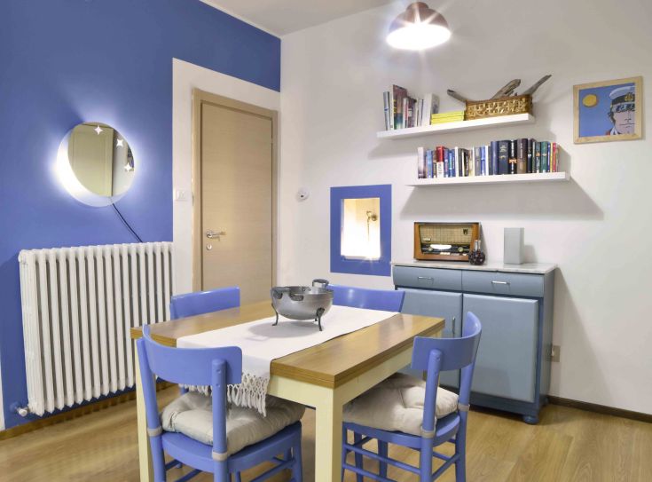 Une cuisine-salon moderne aux tons bleus, idéale pour des moments de convivialité.