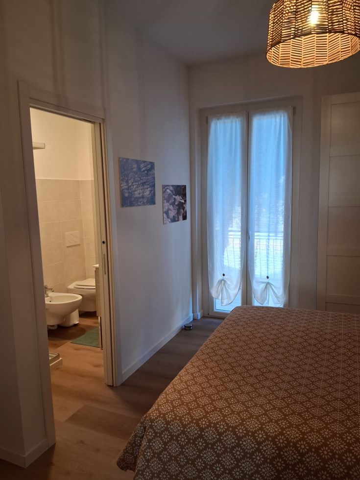 Cozy room with private bathroom and terrace access. Bright and simple decor.