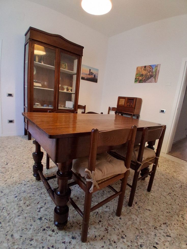 An informal space featuring a wooden table and simple design furniture.