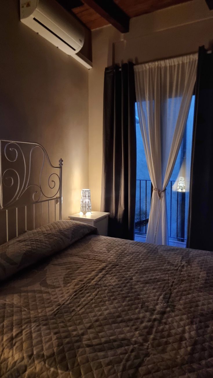 Comfortable room with a double bed, softly lit, perfect for a serene stay.