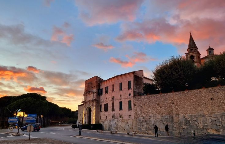 A view of Amelia at sunset, featuring historic buildings and a colorful sky.