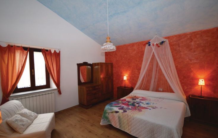 Comfortable room with wooden furniture and warm colors, perfect for a peaceful rest.