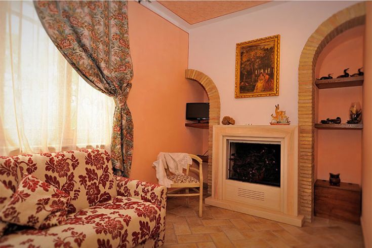 Soggiorno confortevole con mobili semplici e dettagli caratteristici, ideale per momenti di relax.