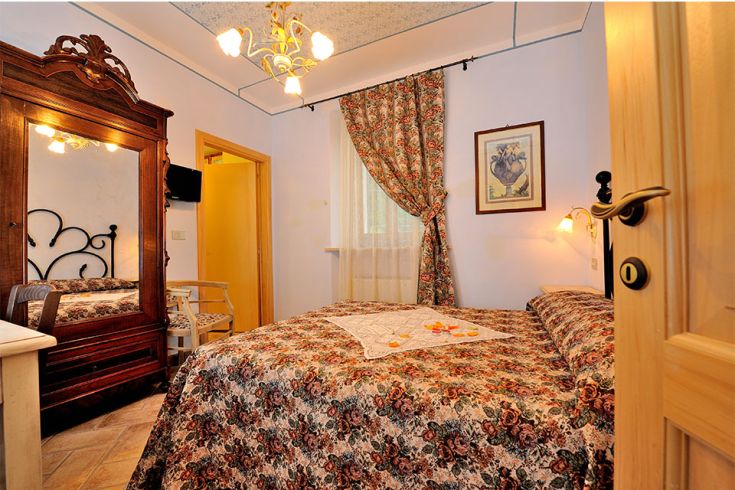 Spazio accogliente con arredi in legno e dettagli floreali, adatto per un soggiorno tranquillo.