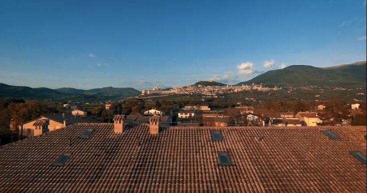 Panorama of Assisi showcasing rooftops and surrounding hills.