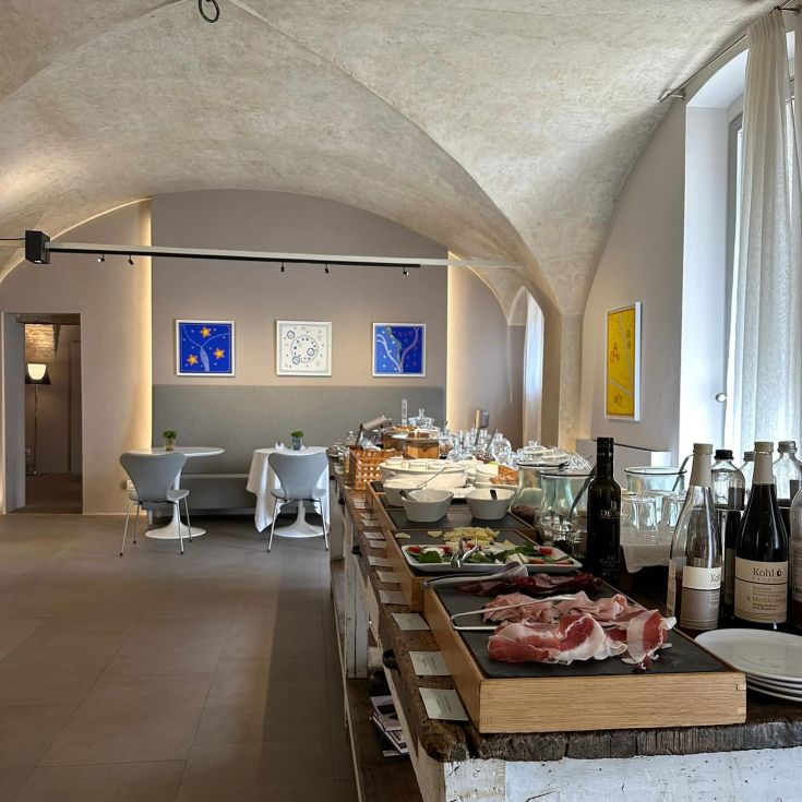 Cozy breakfast space featuring a varied buffet and simple wall decorations.