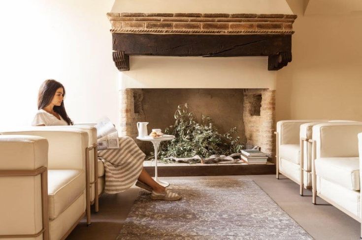 A cozy living room with a fireplace and contemporary furniture, ideal for relaxing and reading.