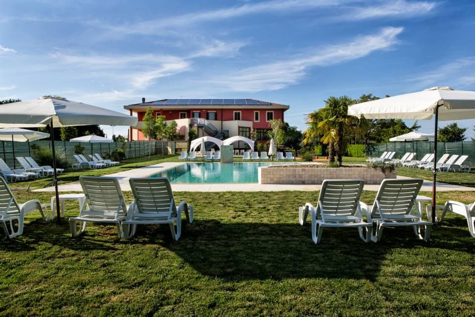 The swimming pool is located in a well-maintained garden, perfect for relaxing among plants and green spaces.