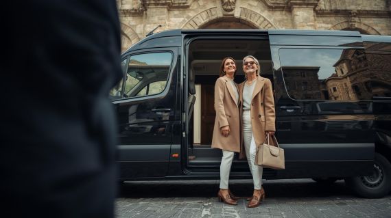 Elegant couple arriving via private executive transfer at a luxury boutique hotel in the historic center of Castiglione del Lago.