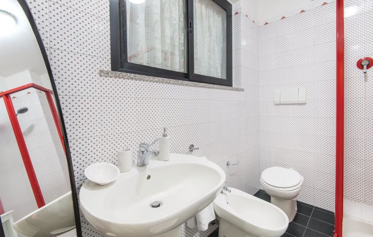 Un bagno luminoso con dettagli semplici e un design minimale.