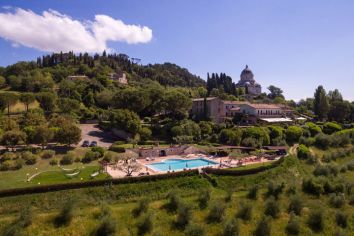 Una scena di una villa con piscina circondata dalla natura umbra.