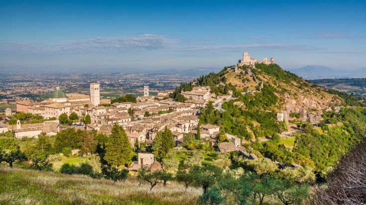 Panorama di un borgo storico, caratterizzato da case tradizionali e un ambiente naturale verdeggiante.