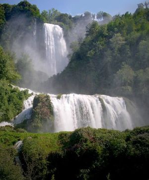 Immagine della cascata delle Marmore in una vegetazione ricca.